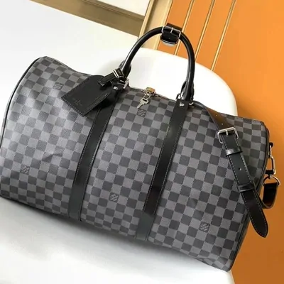 A monogram duffle bag in dark canvas with leather trim